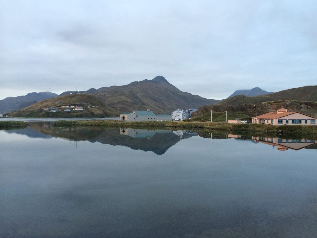 A body of water with a mountain in the background. Aluetian Islands, AK
