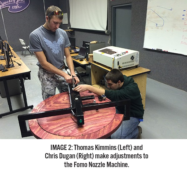 Thomas and Chris work on the Fomo Nozzle Machine