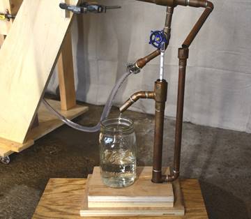 A “parrot” uses a hydrometer to measure alcohol content as it comes out of the condenser.